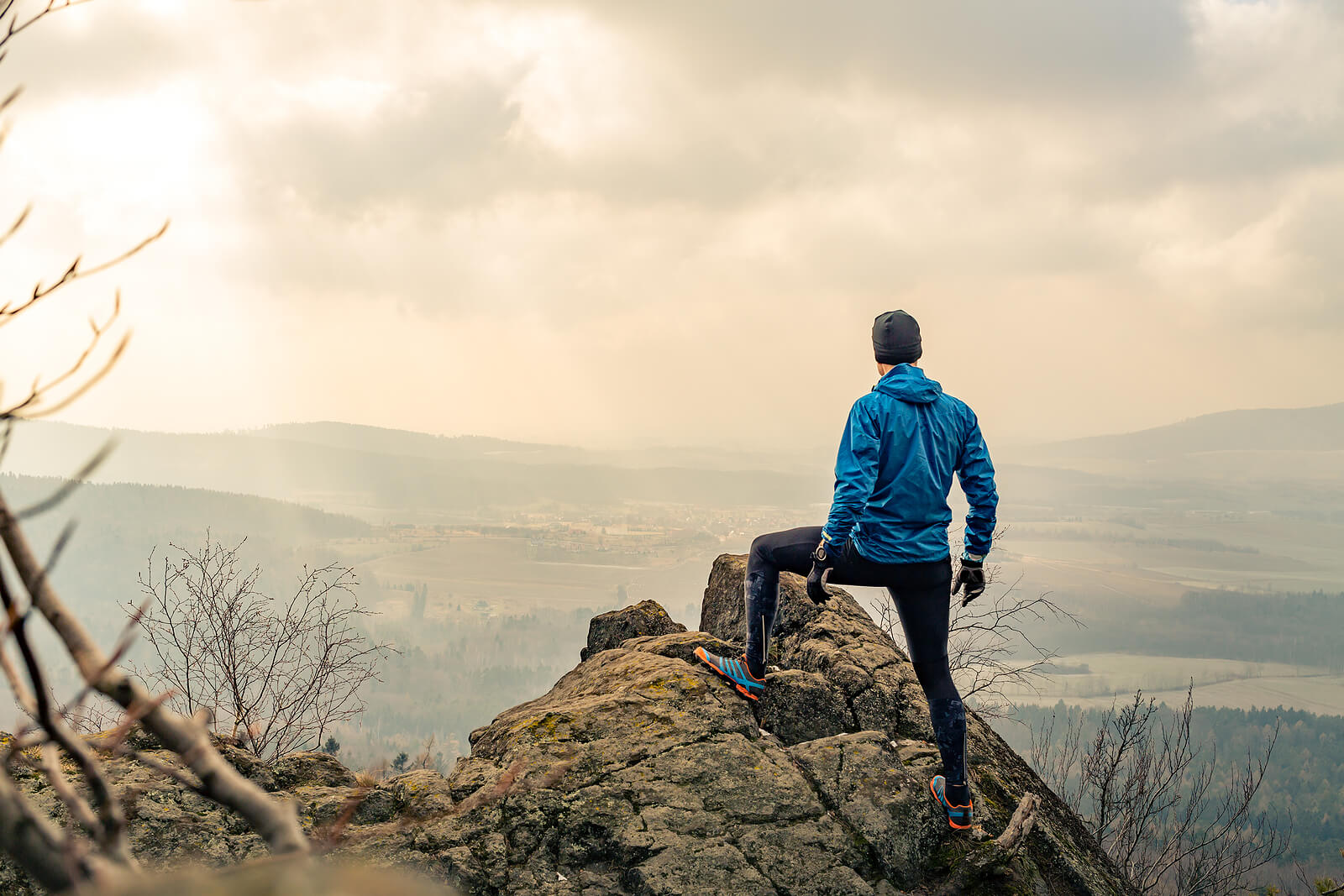 Photo of a man standing on top of a mountain looking out. This photo represents how you can defeat your emotions and behavior with dbt therapy in Georgia.